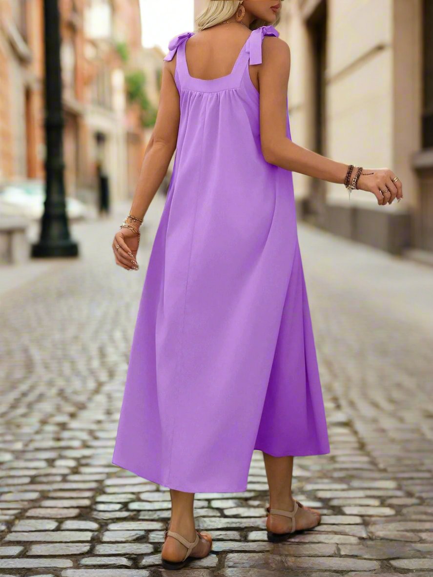 This chic and simple dress is the perfect addition to any summer vacation wardrobe. Made with comfortable spaghetti straps and a pleated design, this dress offers effortless style and elegance. With its solid color, it can be easily dressed up or down for any occasion. Enjoy the warm weather in style with this versatile dress.