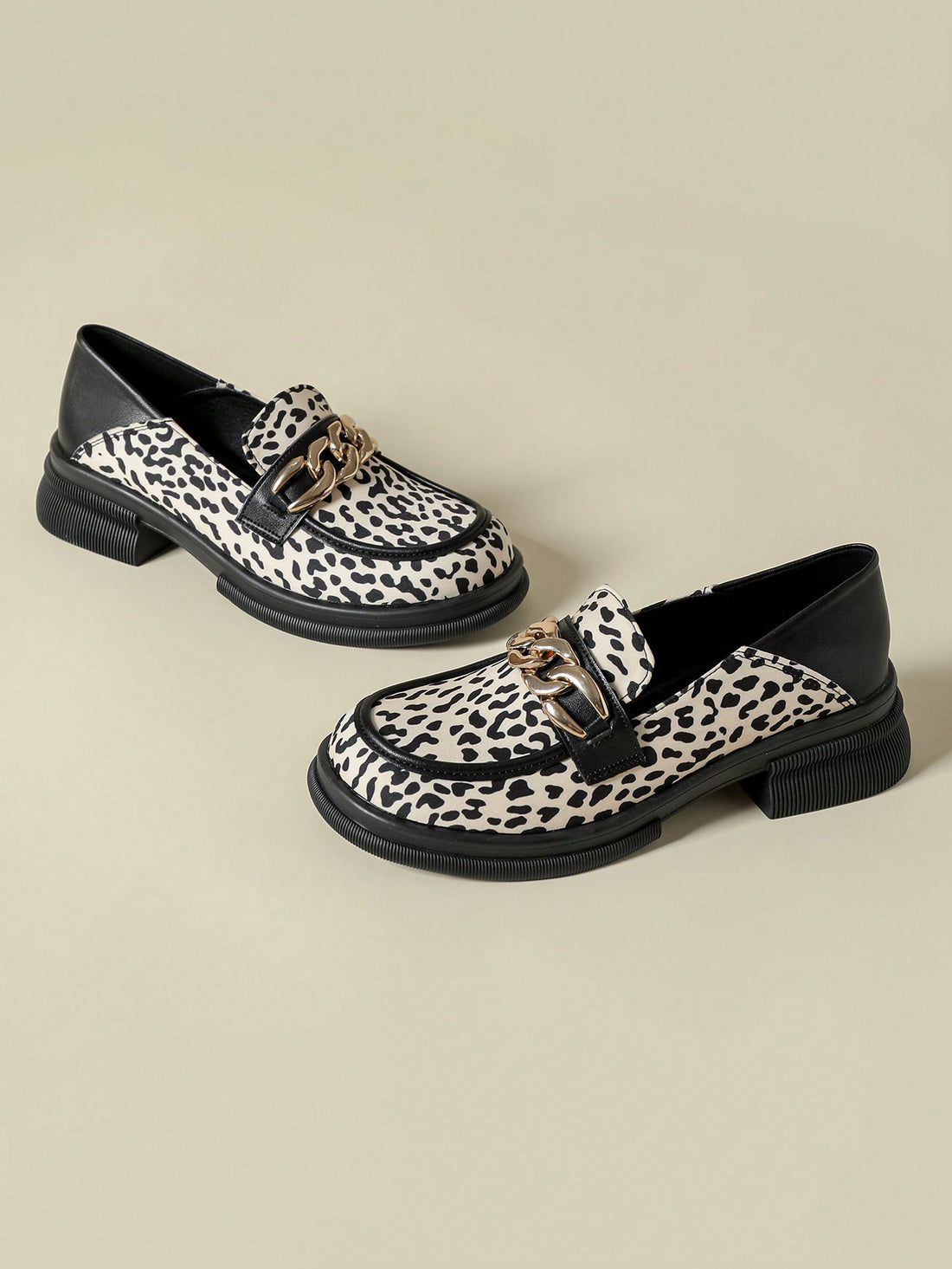 Elevate your shoe game with these chic leopard print mid-chunky heel loafers. Featuring a stylish metal buckle, these loafers add a touch of sophistication to any outfit. With a comfortable mid-height heel, you can rock these all day without sacrificing style. Step out with confidence in these trendy loafers.