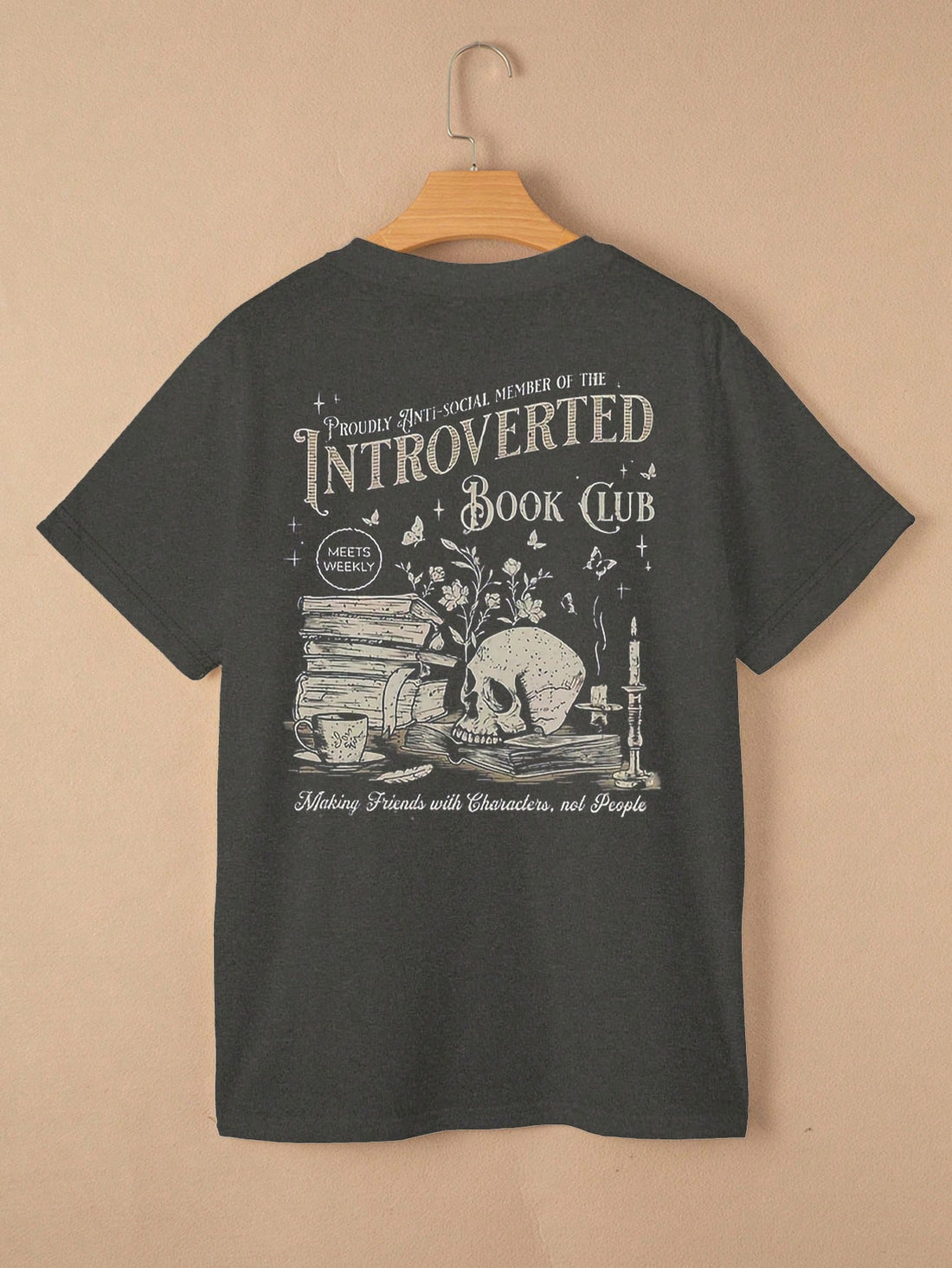 Express your unique style with this Vintage Skull Book Graphic Tee! Featuring a vintage design of a skull reading a book, this tee is perfect for those who love to embrace their individuality. Stand out from the crowd and make a statement with this quirky and fun t-shirt.