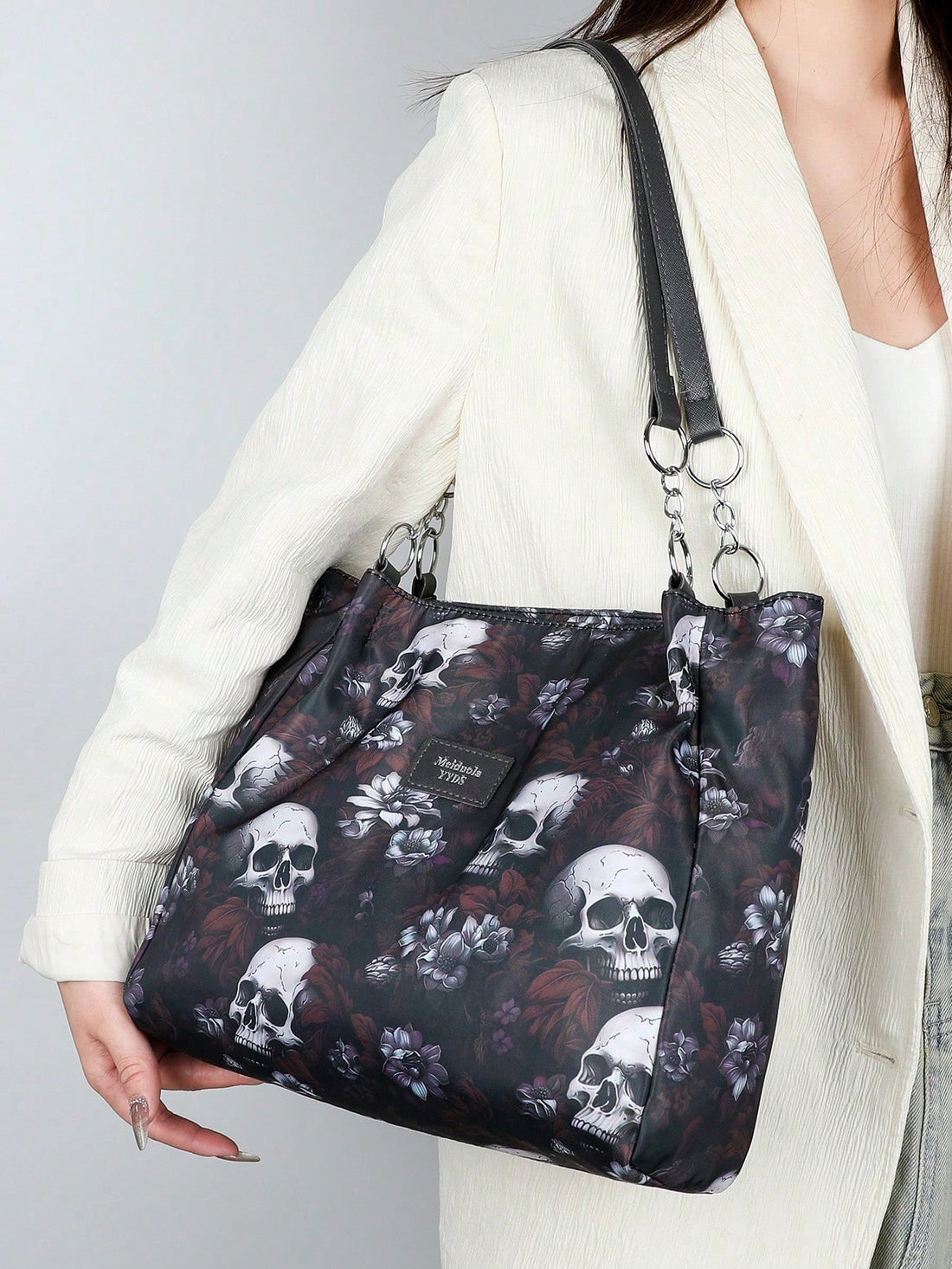 This women's waterproof shoulder bag is perfect for adding a touch of gothic fashion to any outfit, whether it be for a Halloween party or everyday wear. With a unique skull flower print, this retro bag is sure to make a statement. Stay stylish and functional with its waterproof design.