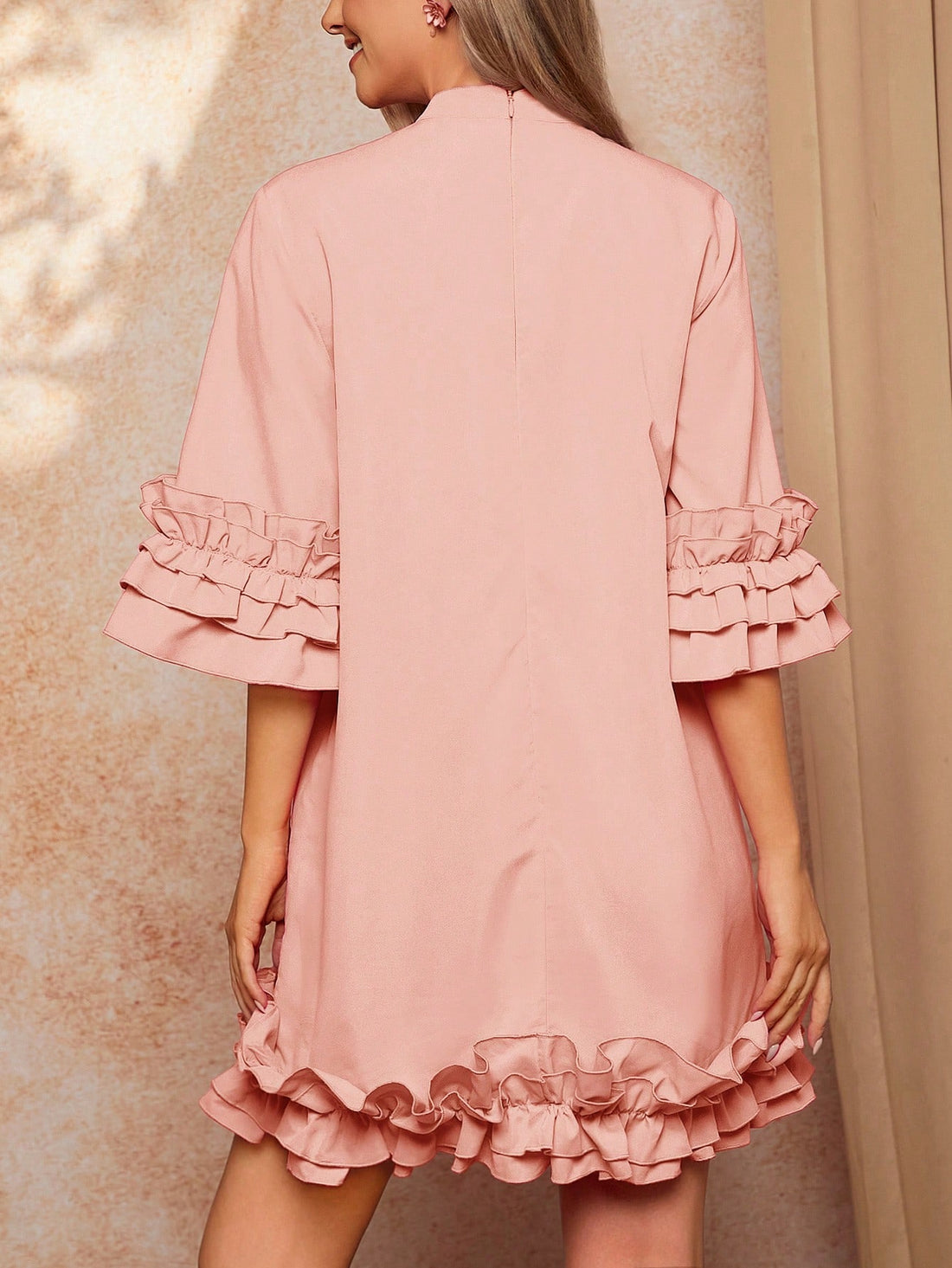 This elegant dress features a tiered ruffle hem and tie collar, making it the perfect addition to any woman's wardrobe. The tiered ruffle hem adds a touch of femininity and sophistication, while the tie collar adds a stylish and chic touch. Perfect for any occasion, this dress will elevate your look and make you feel confident and fashionable.