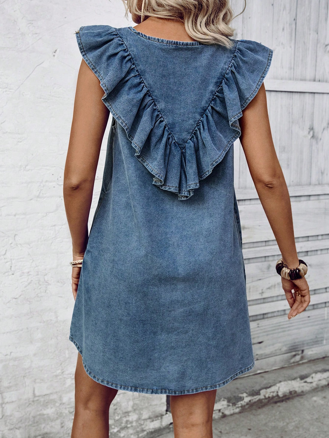 The Chic Sleeveless Ruffled Denim Dress is the ultimate choice for a stylish and comfortable vacation. Made with soft denim fabric, this dress features a trendy ruffled design and a sleeveless cut, perfect for warm weather. Elevate your vacation wardrobe with this chic and versatile dress.