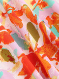 Close-up of pink floral fabric with multicolor painterly print