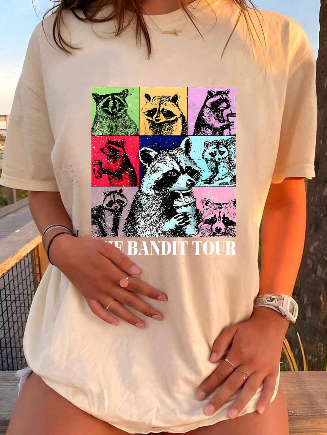 This Coffee-Loving Raccoon Graphic Tee features a fun and quirky design, perfect for any coffee-loving woman. Made from comfortable fabric, this t-shirt is a must-have for any casual outfit. Show off your love for coffee and your unique style with this graphic tee.