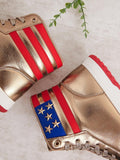 High top sneaker detail with gold laces white midsole and red outsole