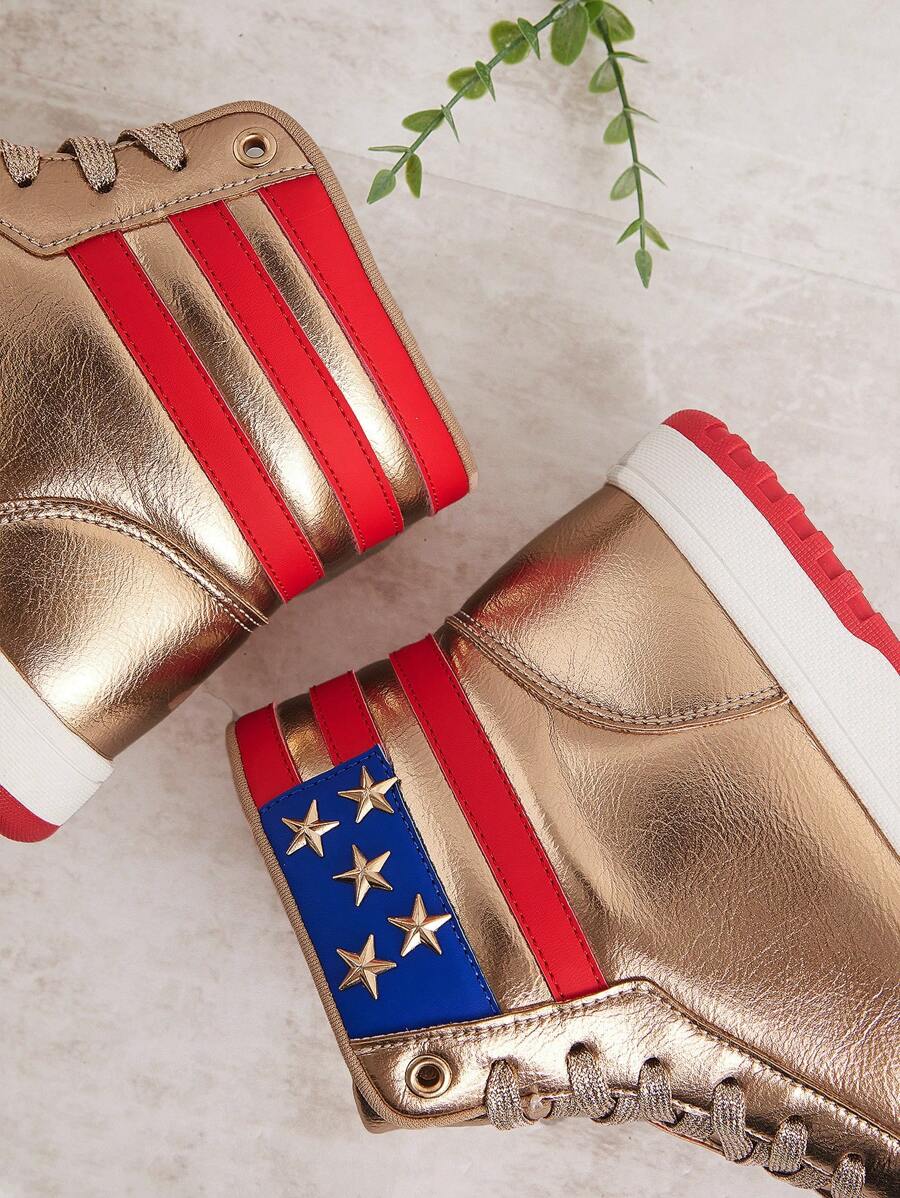 High top sneaker detail with gold laces white midsole and red outsole