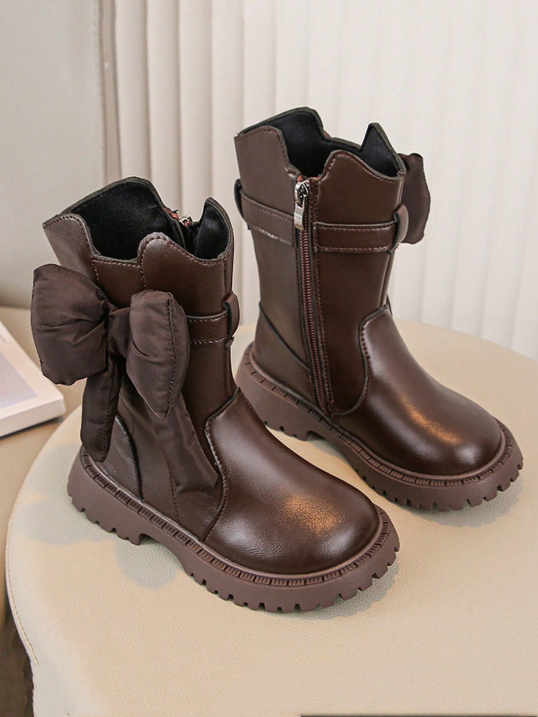 Elevate your little girl's winter wardrobe with our Chic Bowknot Ankle Boots. Designed with a stylish bowknot detail and a thick sole for durability and warmth. These boots will keep her feet comfortable and fashionable during the colder months. A must-have addition to any winter outfit!