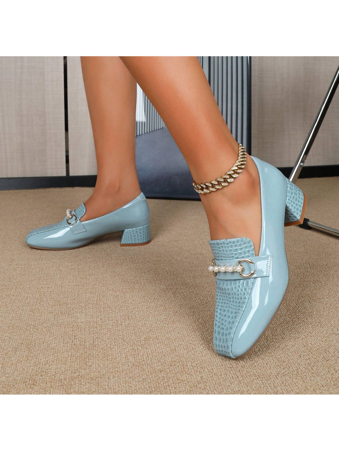 These elegant loafer flats feature chic pearl accents and a chunky heel, making them a versatile choice for any season. Their unique design adds a touch of sophistication to any outfit, while also providing comfortable support. Perfect for any fashion-forward individual looking to elevate their style.