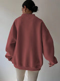 Back view of red oversized sweatshirt with dropped shoulders and long balloon sleeves