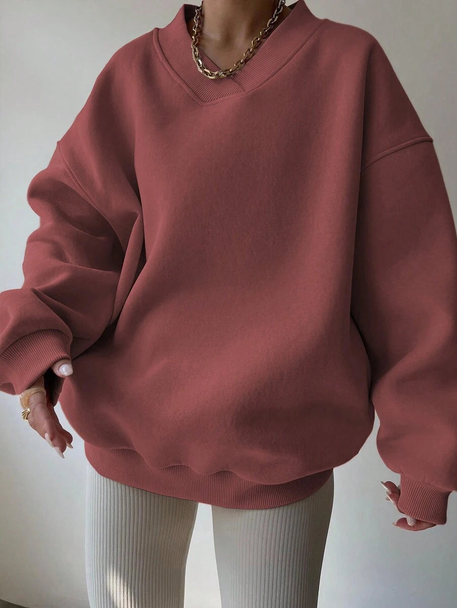 Front view of red oversized V-neck sweatshirt with rib-knit cuffs and hem