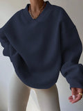 Front view of navy blue oversized V-neck sweatshirt with balloon sleeves