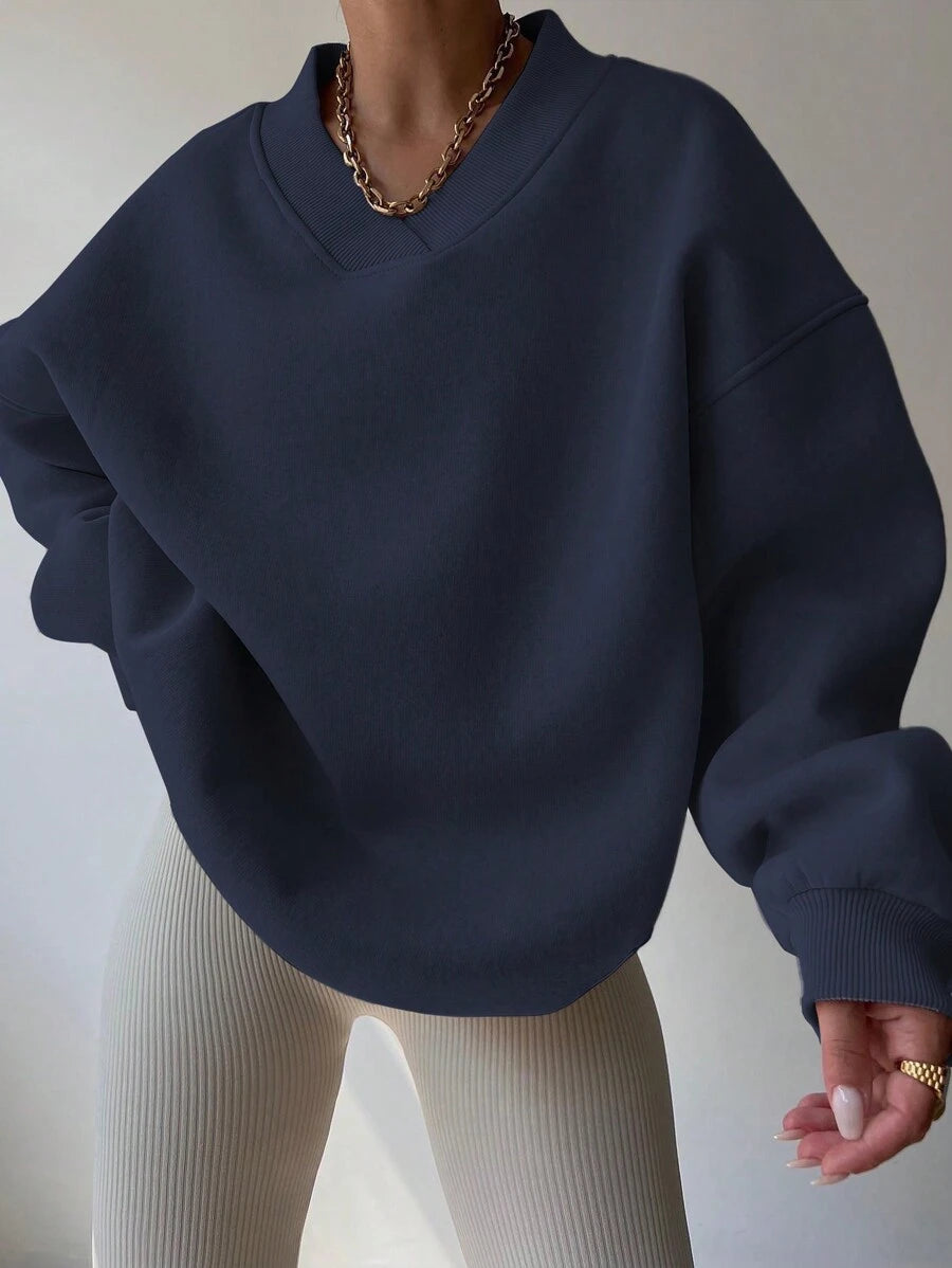 Front view of navy blue oversized V-neck sweatshirt with balloon sleeves