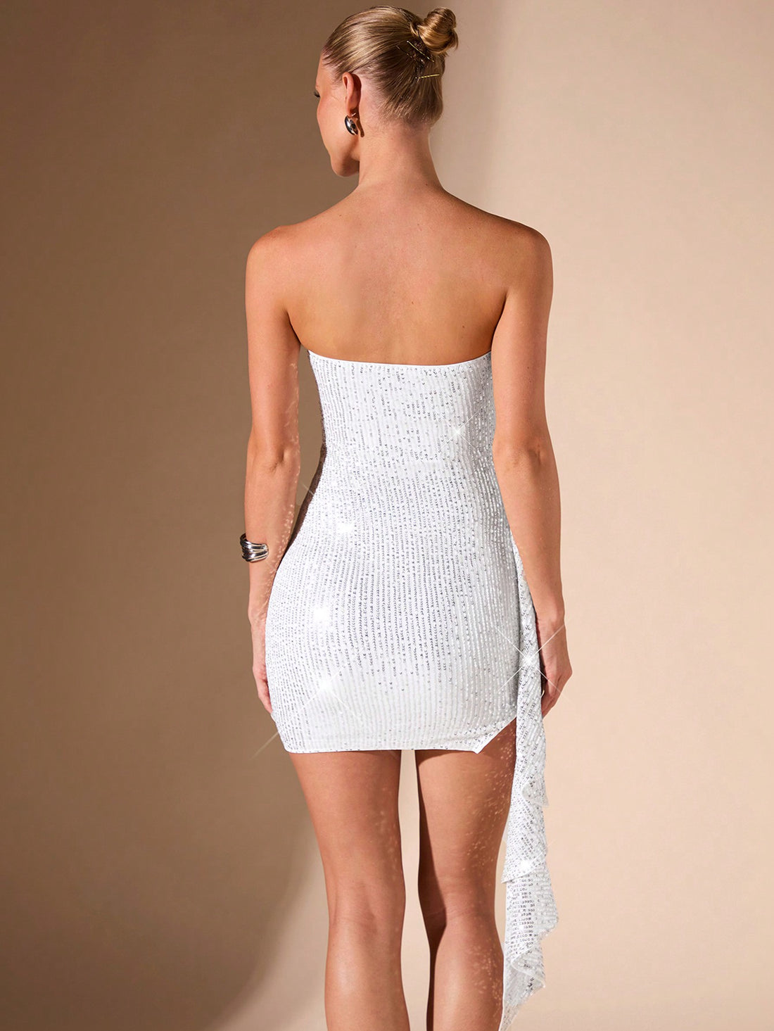 This elegant sleeveless evening dress is designed to make you shine with every step. The ruched detailing enhances your figure while the high-slit adds a touch of flair. The beaded sequin detail gives the dress a sparkling finish. Make a statement at your next formal event with this chic and glamorous dress.