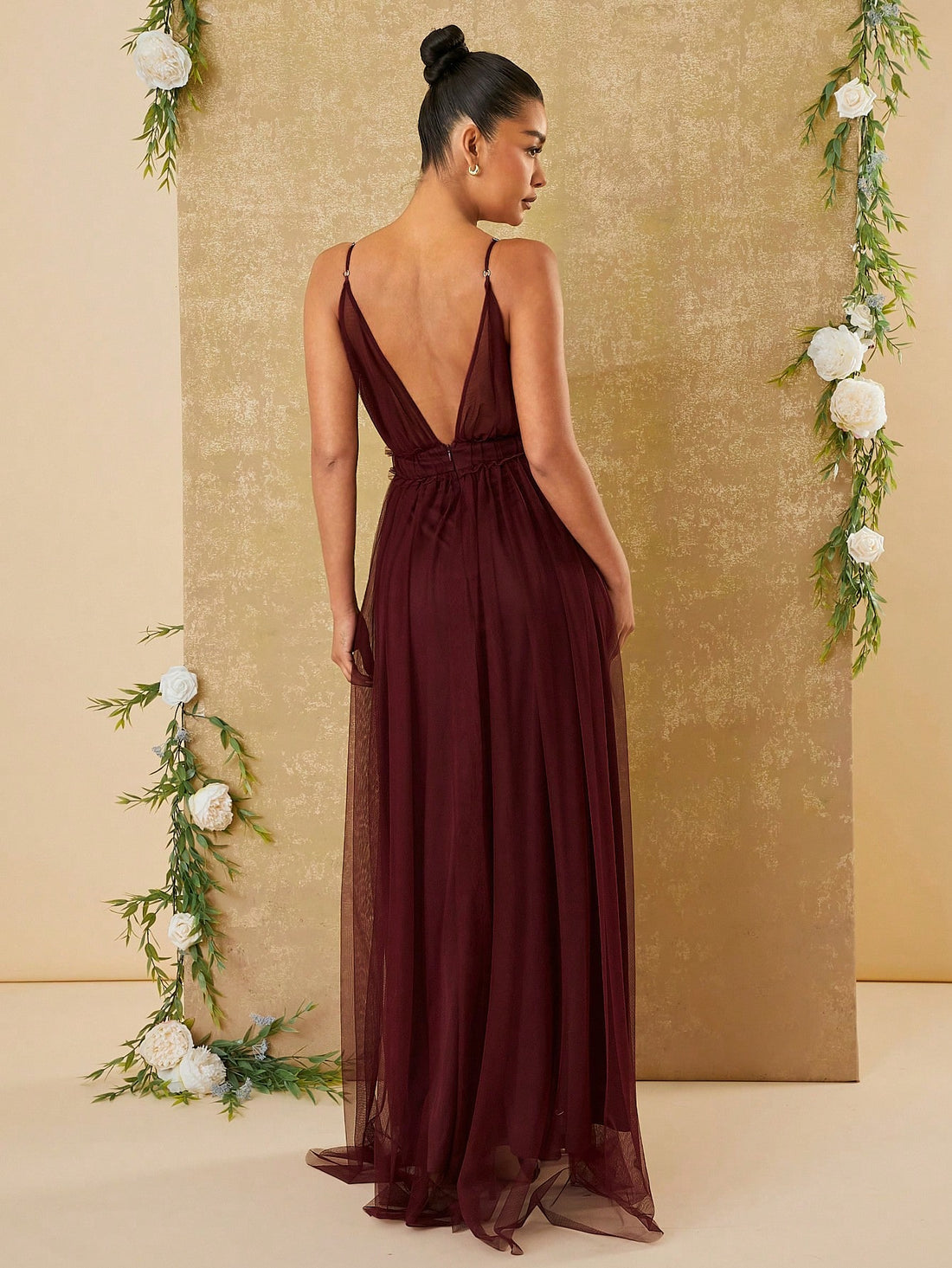 Expertly crafted with a sophisticated design, this elegant tulle maxi dress features a plunging neckline and dual slits. The perfect blend of haute couture style and modern elegance, this dress is a must-have for any formal occasion. Feel confident and stylish in this one-of-a-kind piece.