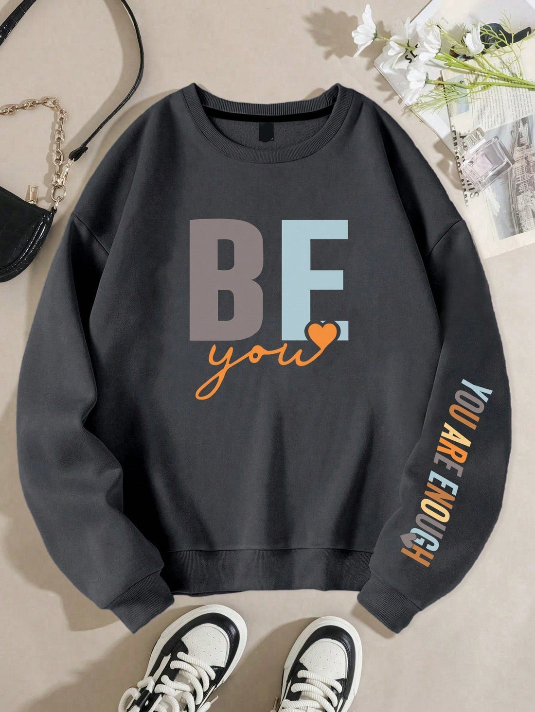This empowering sweatshirt for women features a bold 'Be You, You Are Enough' letter print, inspiring individuals to embrace their true selves. Made with quality materials, this sweatshirt is not only stylish but comfortable, allowing you to confidently express yourself and spread a positive message to others.