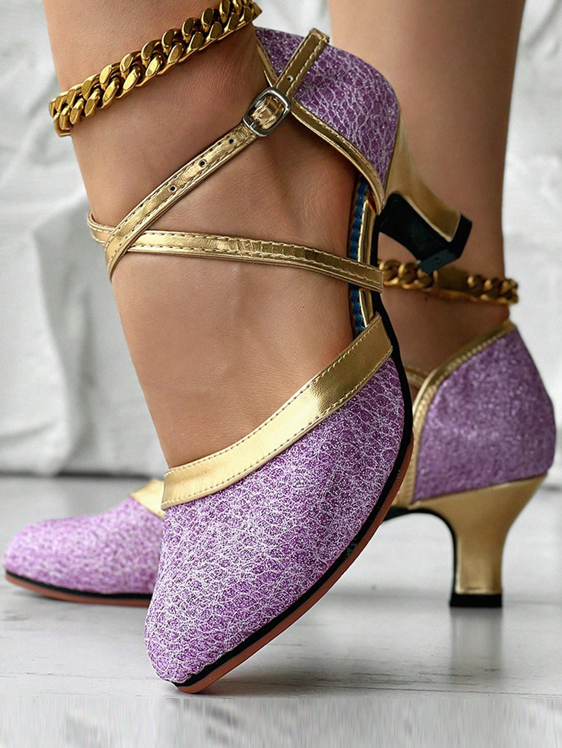 These Elegant Purple & Gold Metallic Sequin Latin Dance Shoes with Chunky Mid Heel are a perfect blend of style and functionality. Made with a chunky mid heel, they provide comfortable support while dancing. The vibrant colors and metallic sequin design add a touch of elegance to any dance routine. Step out in confidence and style with these high-quality dance shoes.