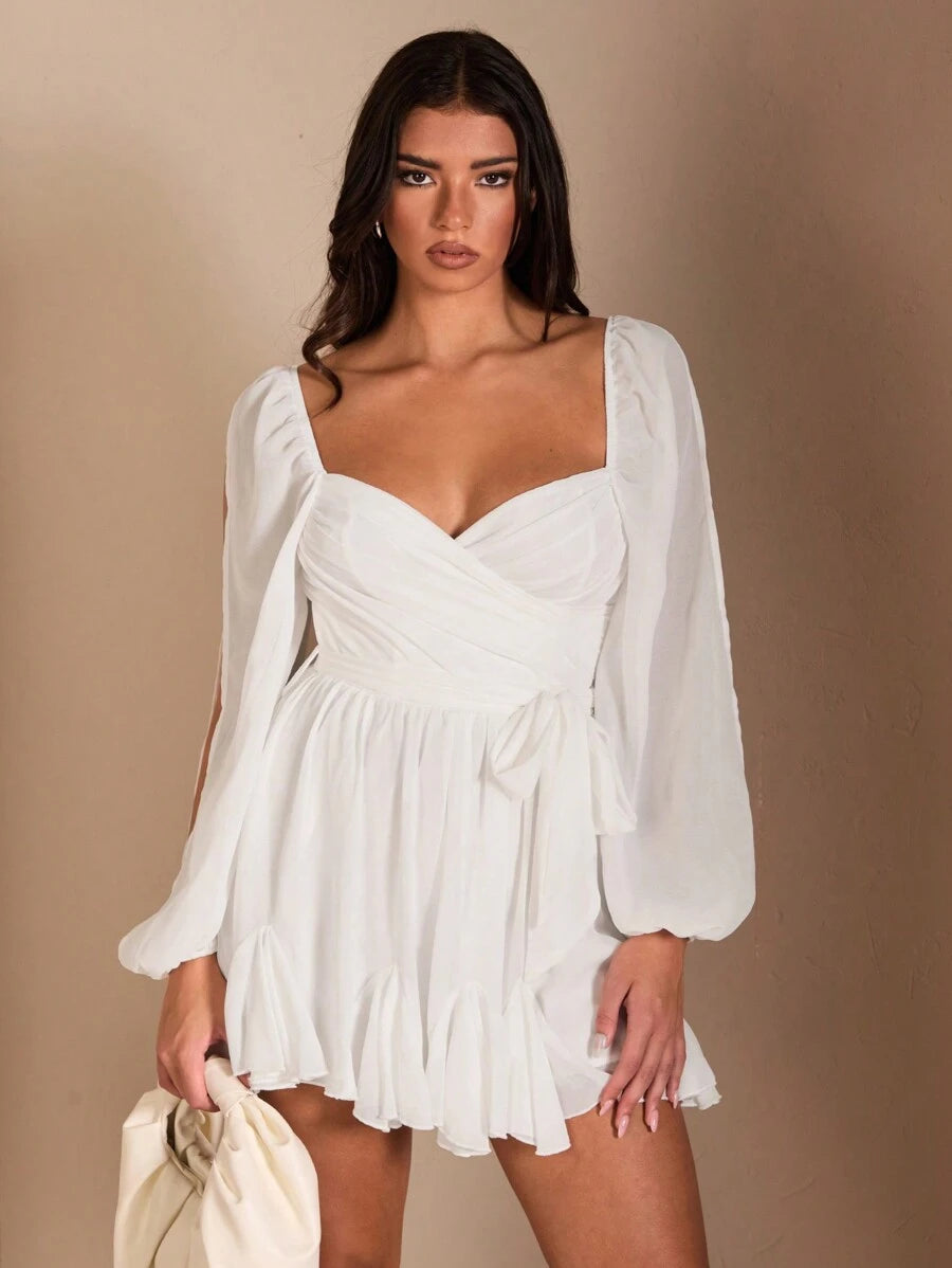 White chiffon mini dress with sweetheart neckline wrap bodice side tie sheer bishop sleeves and ruffle hem
