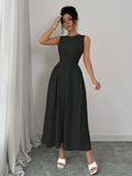 Front view of black sleeveless midi dress with round neck and gathered skirt