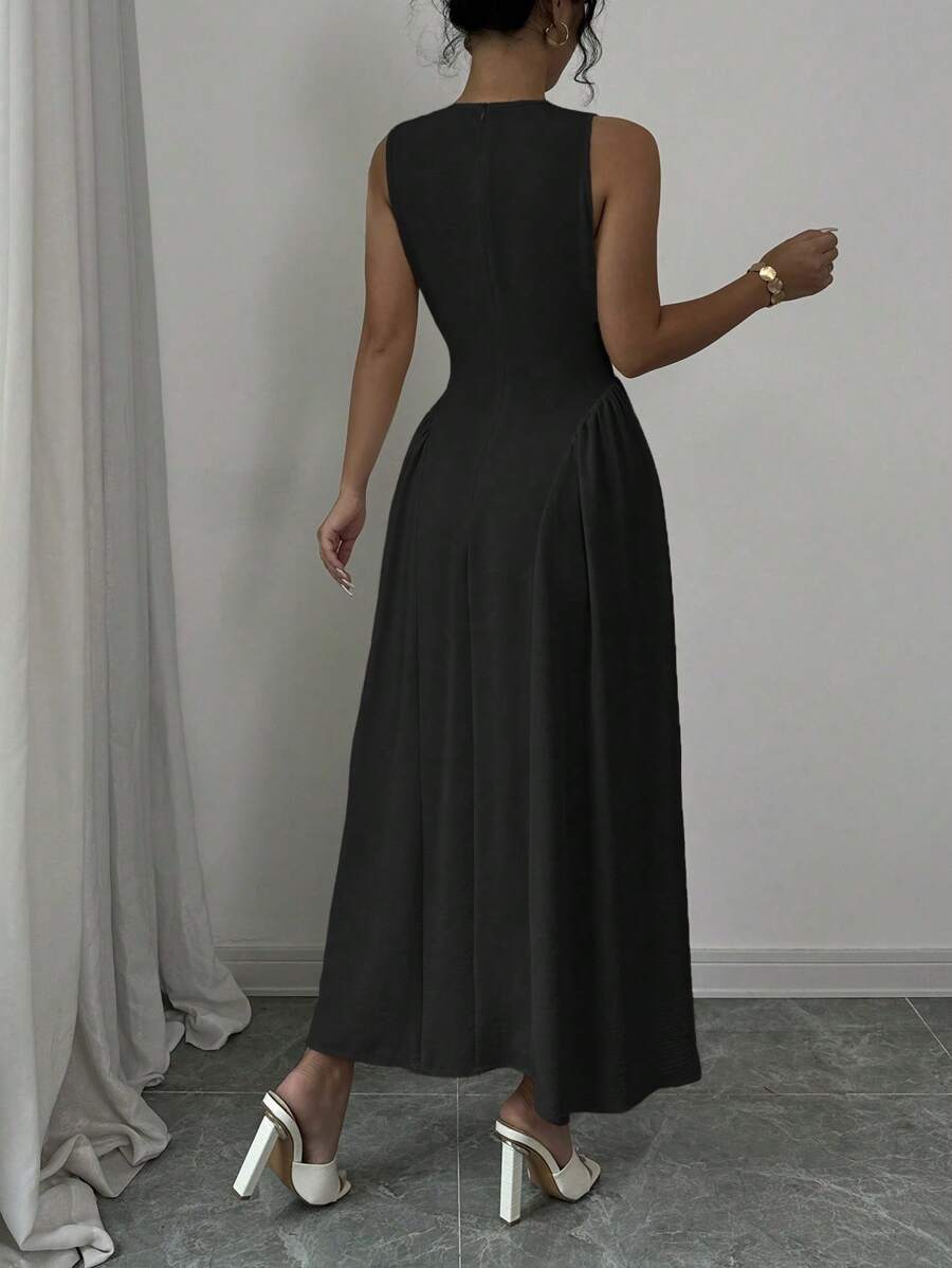 Back view of black fit and flare midi dress with center seam