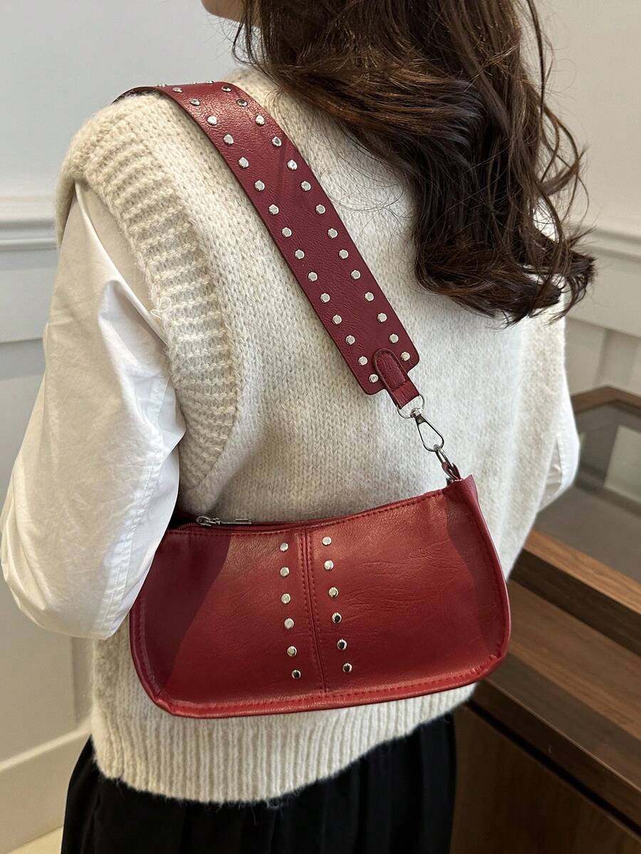 Add a dash of retro charm to your outfit with this vintage-inspired rectangular handbag. Featuring eye-catching rivet accents and a smooth zipper closure, it’s the perfect playful companion for your daily adventures. Comfortable to wear on the shoulder and spacious enough for your essentials, this chic bag brings both style and function to your look.