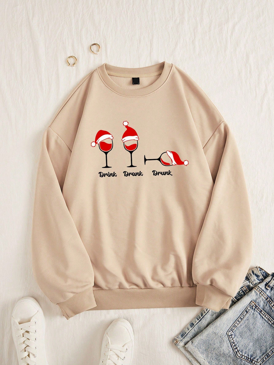 Stay festive and cozy this holiday season with our Cheers to the Season sweatshirt. Made with soft and warm fabric, this sweatshirt features a playful 'Drink Drank Drunk' design that will surely bring a smile to your face. Perfect for any holiday party or night in, spread some cheer and get yours today!