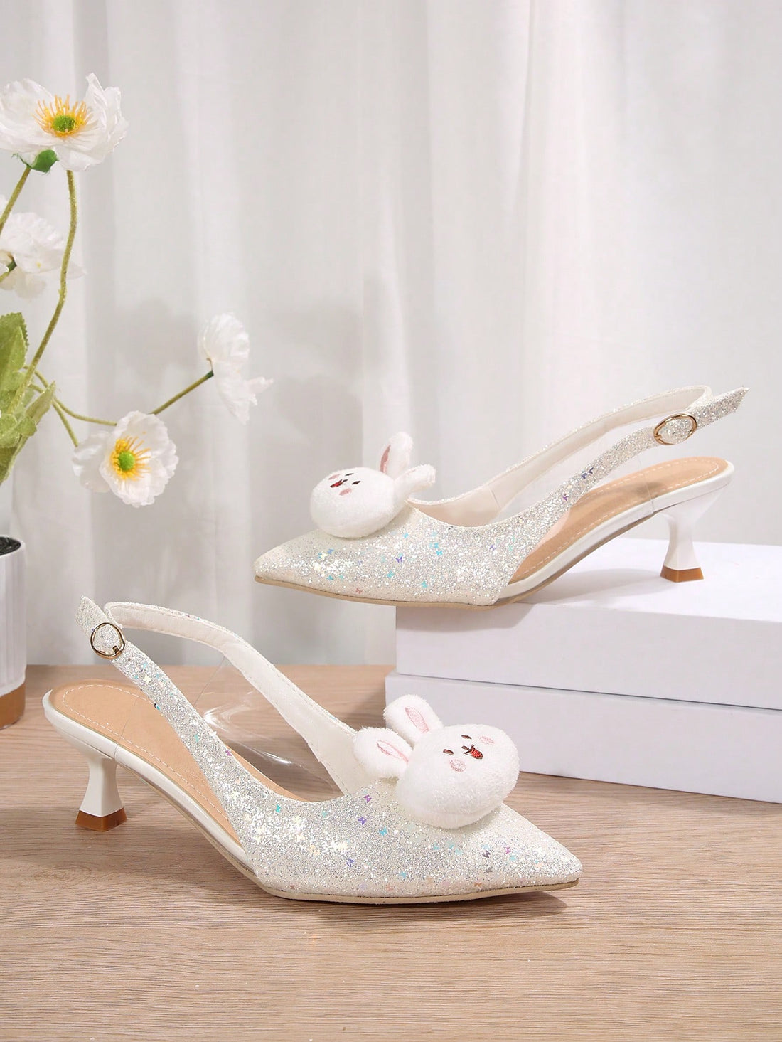Elevate your style with Chic Sparkle: Trendy Pointed Toe High Heel Sandals. The sleek pointed toe and high heels add sophistication, while the adorable rabbit decor adds a playful touch. These sandals are perfect for any occasion, making you feel confident and stylish.