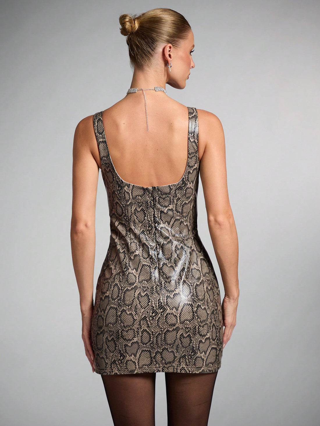 Get ready to stand out in the Wild Chic: Brown Snakeskin Print Mini Dress. This stunning dress features a bold snakeskin print that will turn heads wherever you go. Perfect for a night out, this dress will make you feel confident and stylish. Its mini length adds a touch of flirtiness to your look, making it a must-have in your wardrobe. Elevate your style with this wild and chic dress.