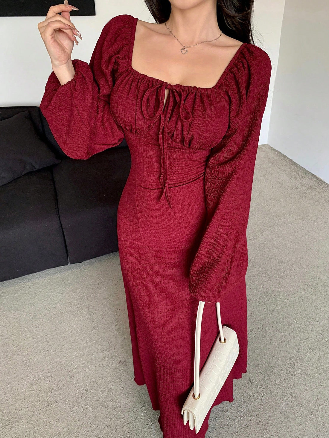 Effortlessly elegant, this dress features a chic square neck and ruched tie-front details. With long sleeves, it's perfect for cooler weather and adds a touch of sophistication to any outfit. Get ready to turn heads in this stylish and versatile dress!