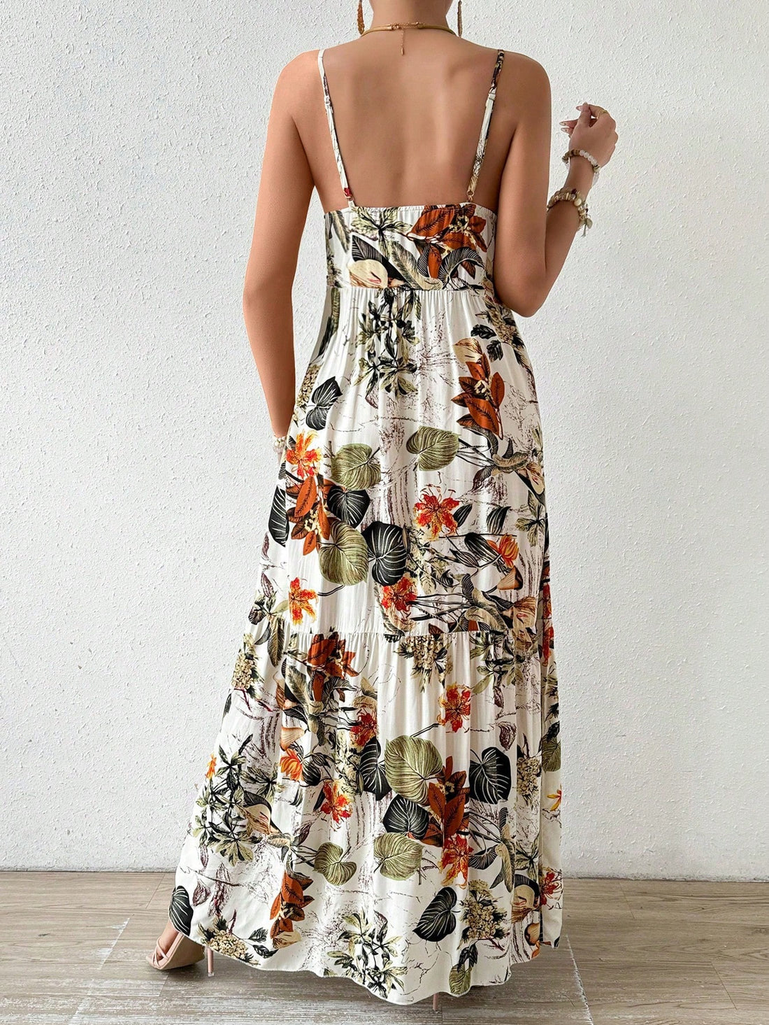 This dress has got you covered for all your holiday outings! The chic plant print and ruffle hem give it a playful touch, while the spaghetti straps add a flirty appeal. Perfect for any occasion, you'll be turning heads wherever you go. Get ready to slay in this maxi dress!