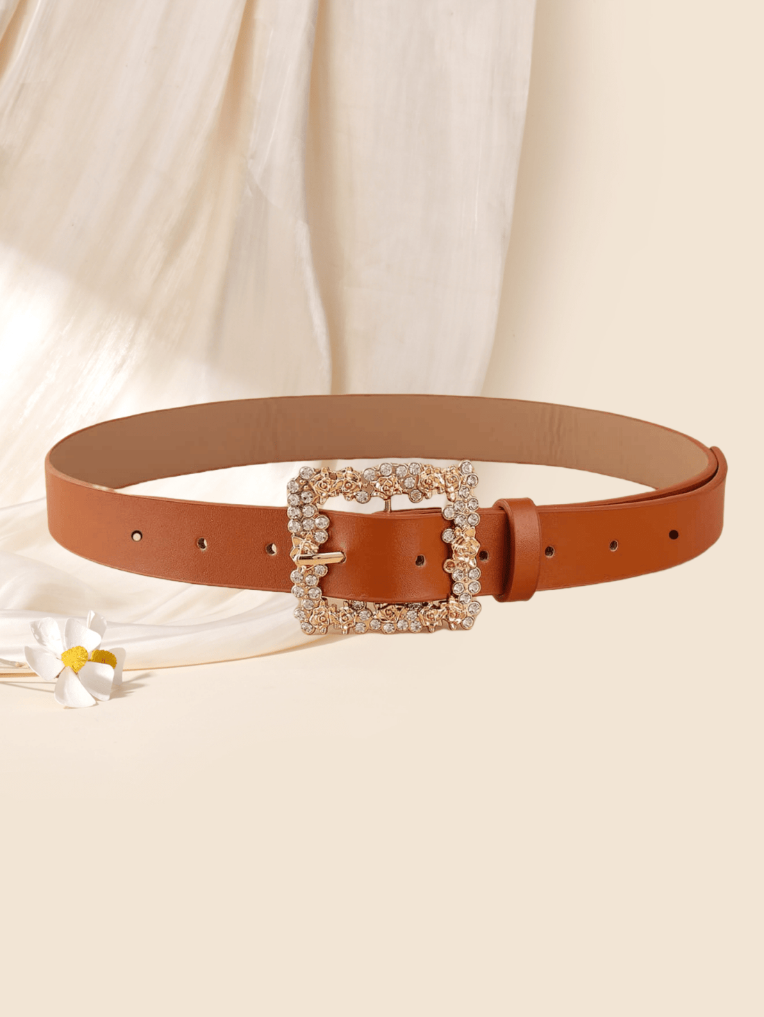 This chic fashion belt for women features a square flower rhinestone buckle that adds a touch of elegance to any outfit. Versatile and stylish, it pairs well with both casual and formal attire. Show off your fashion expertise with this must-have accessory.