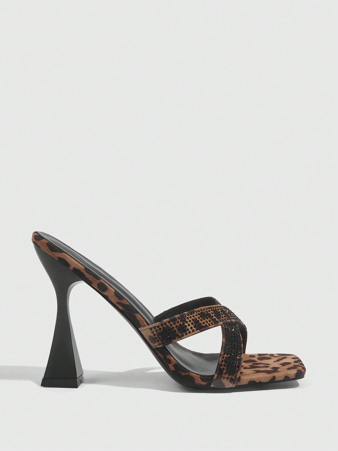 Step out in style with these Chic Leopard Velvet High Heel Mules, featuring a dazzling glitter strap and a trendy square toe design. Perfect for adding a playful touch to any outfit, these sandals combine bold leopard print with sparkling accents to make your look unforgettable. Elevate your wardrobe with comfort and flair in every step.