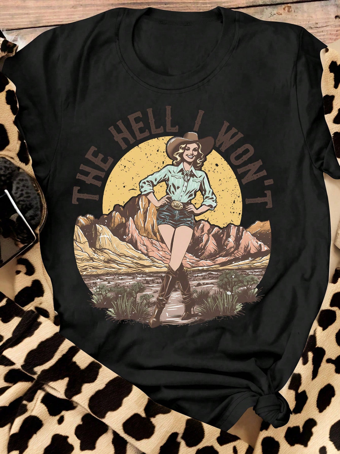 Embrace the wild west in style with our Vintage Western Landscape Graphic Tee! This playful, plus size t-shirt features a vintage western landscape graphic and a comfortable, casual short sleeve design. Perfect for any modern cowgirl. Giddy up!