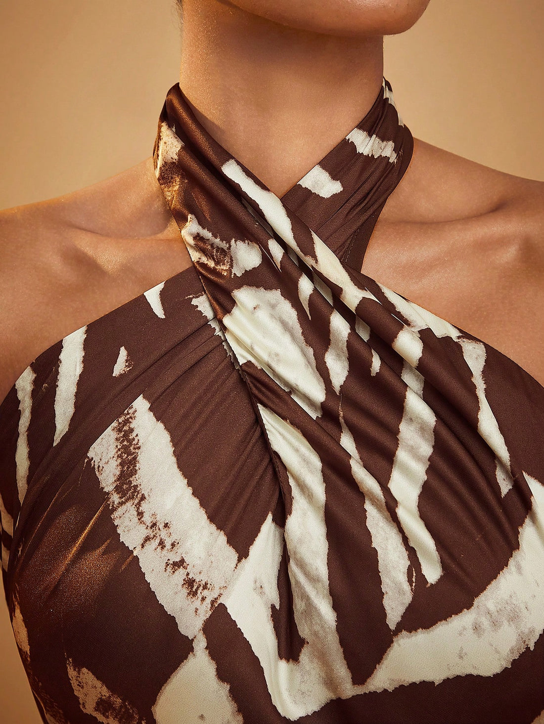 Effortlessly chic with an elegant animal print, this maxi dress is perfect for any occasion. With its cross halter design, you'll feel stylish and comfortable at the same time. Be the talk of the town in this versatile and fashionable dress.