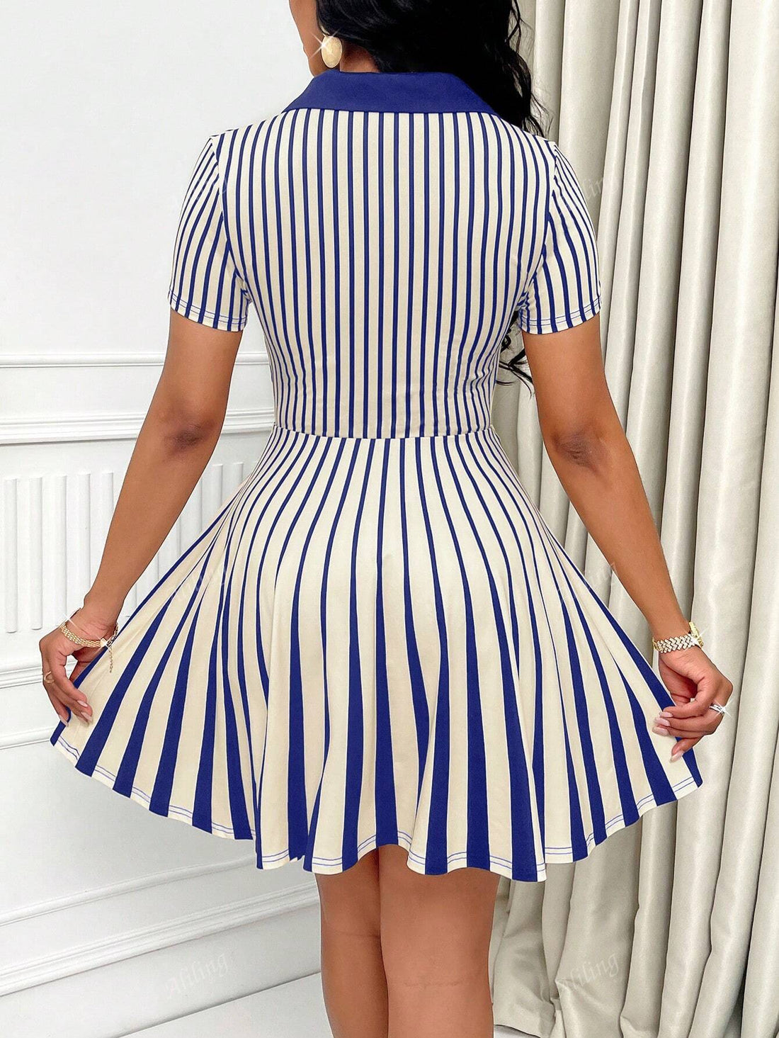 This chic striped dress exudes effortless elegance with its polo collar and short sleeves. Perfect for any occasion, it combines style and comfort in one versatile piece. Elevate your wardrobe with this must-have dress.