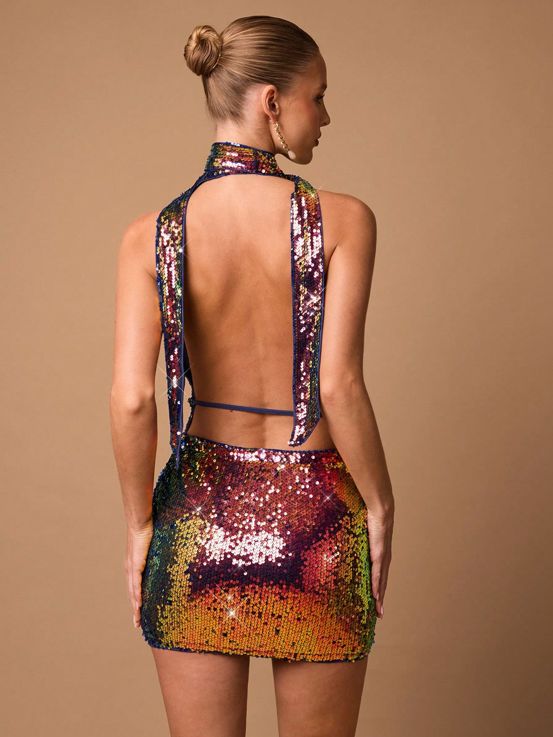 Get ready to turn heads and make a statement with our Shimmering Elegance: Backless Sequin Mini Dress! Perfect for any formal celebration or night out, this dress features dazzling sequins and a backless design that will showcase your style and confidence. Say goodbye to boring outfits and hello to a bold and elegant look!