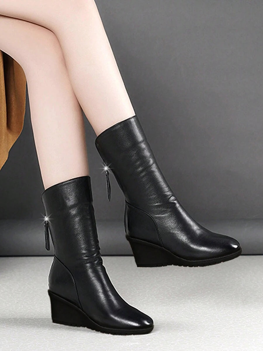Step into the season with boots that mean business—and style. These mid-calf wedge heel boots blend comfort with that effortless cool factor you've been craving. The flat wedge design keeps you grounded while the sleek silhouette works overtime with everything from jeans to dresses. Perfect for autumn strolls and winter adventures, they're the reliable pair that'll have you reaching for them again and again. Because looking good shouldn't feel like a chore.