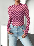 Front three-quarter view of pink and dark berry checkerboard fitted knit top