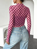 Rear three-quarter view of pink checkerboard long-sleeve shirt with stand collar