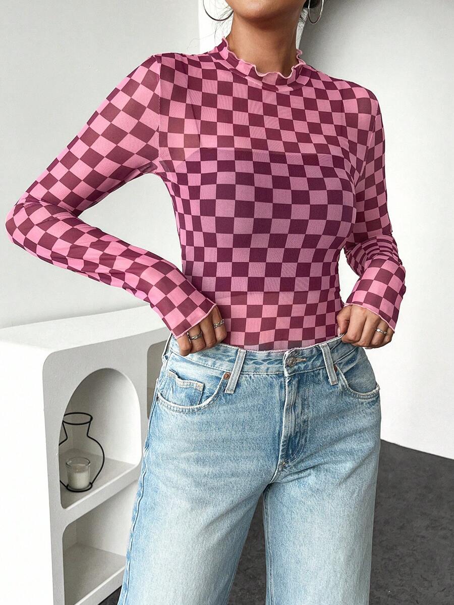 Front styled view of pink checkerboard fitted knit top with lettuce-trim edges
