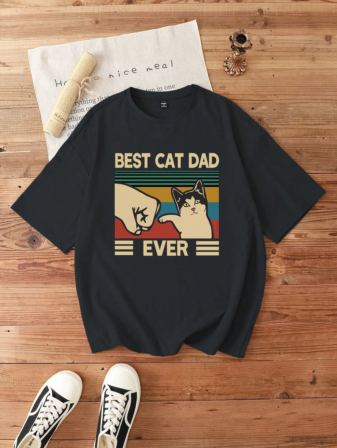 Be the coolest guy in town with this playful and quirky t-shirt! The cartoon letter graphic adds a touch of humor to your wardrobe, while the short-sleeves keep it casual and comfortable. Show off your unique style with this must-have tee. (No shirt, Sherlock!)