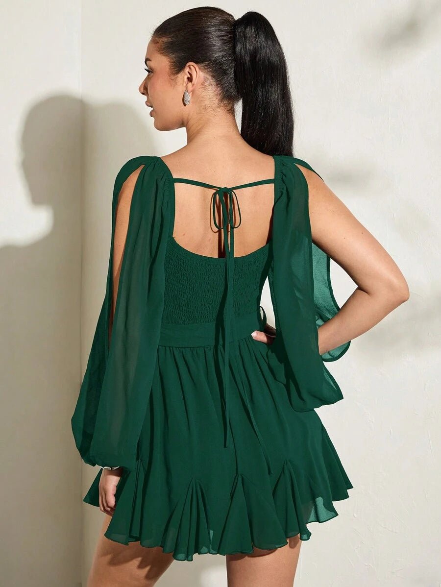 Back view emerald green chiffon mini dress with tie-back detail shirred back and split balloon sleeves