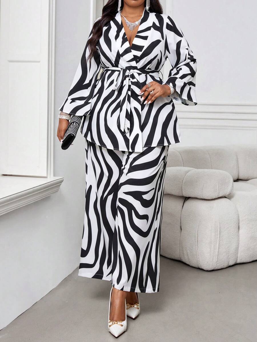 Elevate your seasonal wardrobe with this chic two-piece set designed for the modern, confident woman. The crisp white long-sleeve top pairs perfectly with tailored pants, creating an effortlessly polished look that transitions seamlessly from office to evening plans. Crafted with plus-size proportions in mind, this set celebrates your curves while delivering timeless elegance. Whether you're layering through chilly fall days or making a statement this winter, you'll feel fabulous and put-together. A versati
