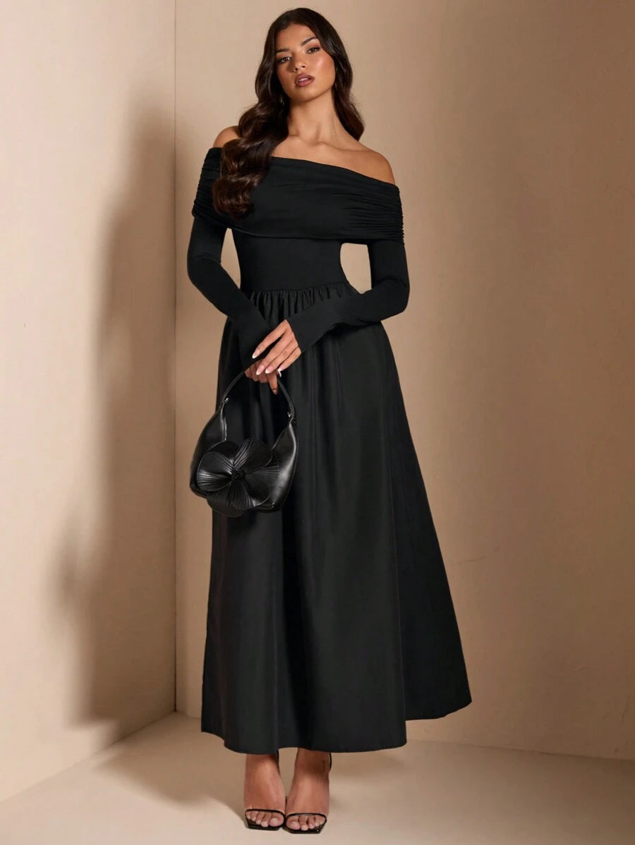Black off-shoulder maxi dress with floral handbag