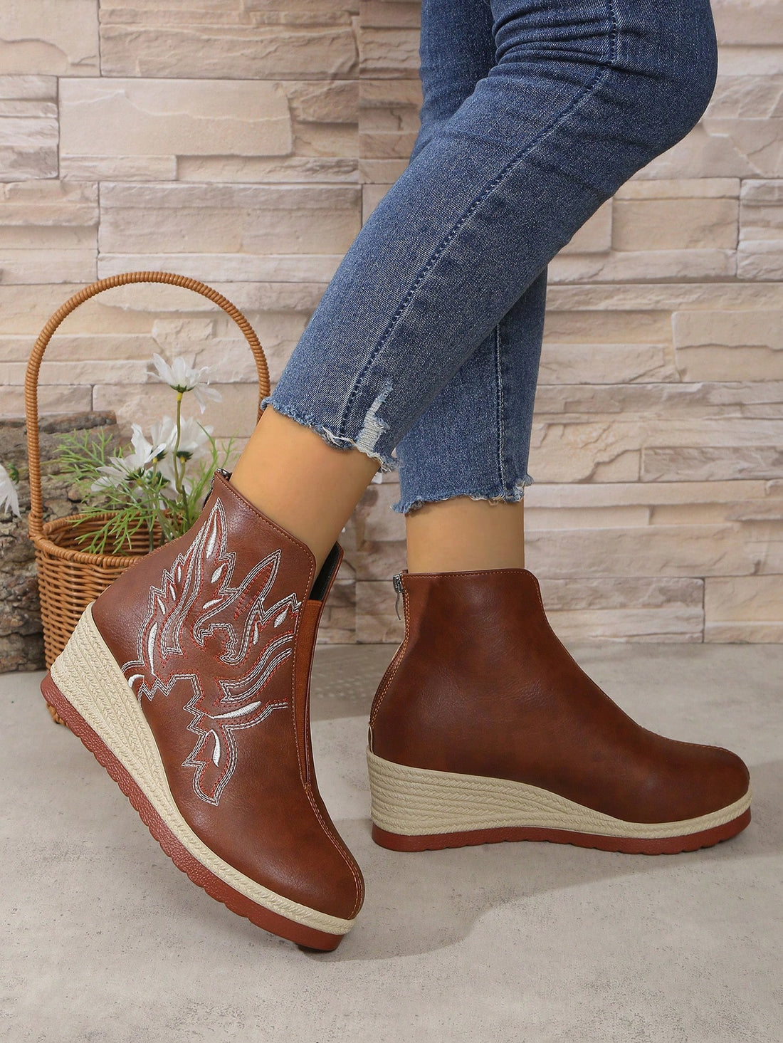 With a touch of floral elegance, these Embroidered Wedge Ankle Boots feature a sleek back zipper for easy on and off. The wedge heel provides the perfect balance of style and comfort, making them a fashionable addition to any ensemble. Step up your shoe game with these versatile and chic boots.