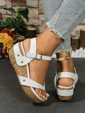Side and rear on-foot view of white buckle-strap wedge sandals with dark tread