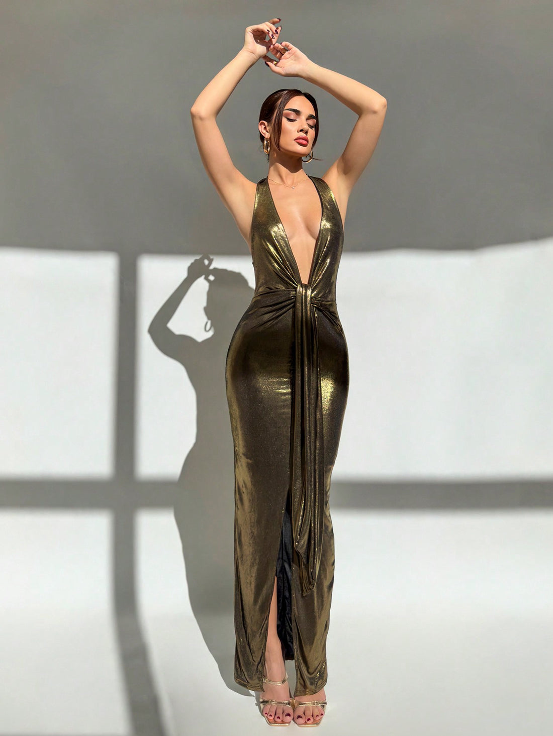 Turn heads at your next event in this show-stopping halter dress. The plunging V-neckline and strategic ruching create an alluring silhouette that flatters every curve, while the elegant back tie adds an unexpected twist of sophistication. Perfect for parties, nights out, or any occasion where you want to feel absolutely fabulous. Slip into confidence and let this dress do the talking.