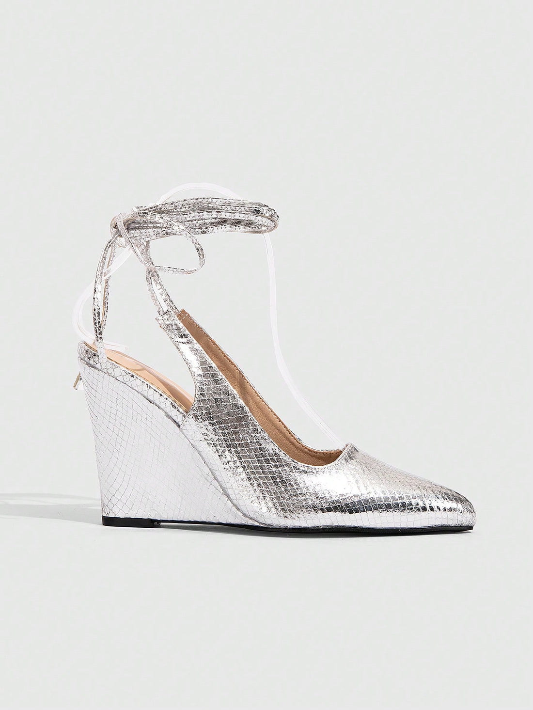 Get ready to turn heads with these Pointy Toe Snake Skin Lace-Up Wedge Pumps! Perfect for parties and holiday events, these chic heels add a touch of glam to any outfit. The unique snake skin design and lace-up style give these pumps a playful edge. So go ahead, make a statement with your footwear!