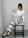 Black and white striped knit midi dress with tiered ruffle hem styled with black slingback heels