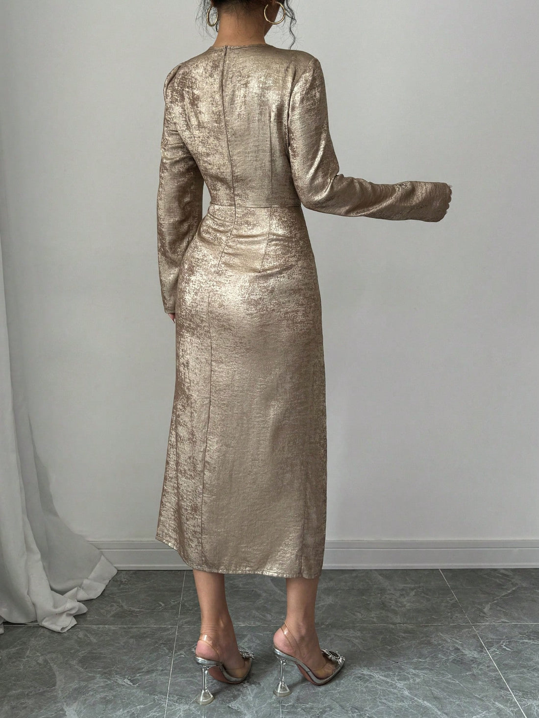 Embrace the season in this stunning asymmetrical bodycon maxi dress that's equal parts sophisticated and show-stopping. The shimmering gold foil detailing catches the light beautifully, adding just the right amount of glamour to your autumn wardrobe. With its flattering fitted silhouette and dramatic asymmetrical hemline, this dress transitions effortlessly from evening events to upscale dinners. Perfect for anyone who loves making a bold fashion statement while staying timelessly elegant. Slip it on and le