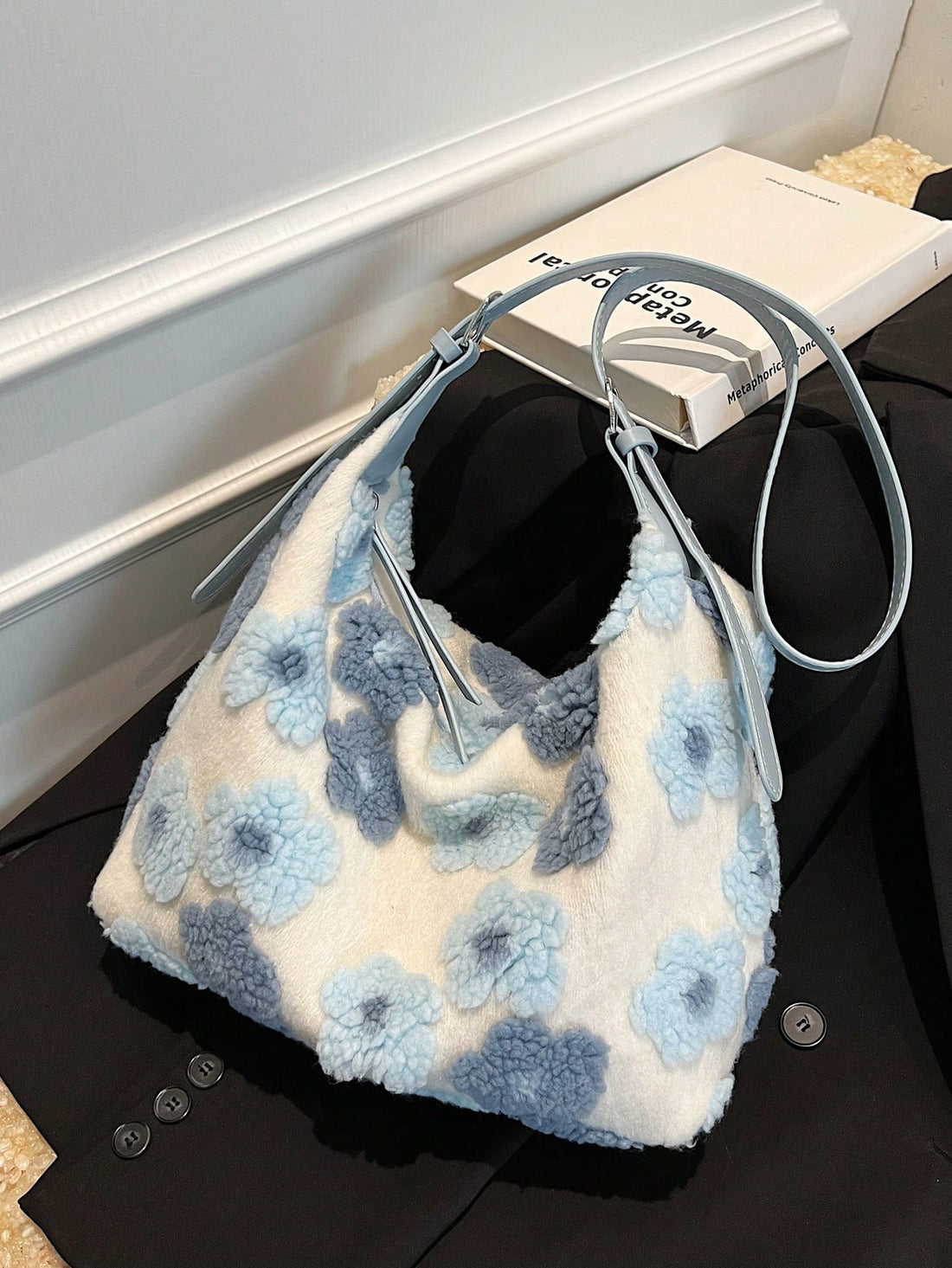Introducing the Chic Blue Plush Bucket Bag - perfect for autumn and winter. This bag features a stylish floral design and plush material that is both fashionable and functional. The unique bucket shape allows for plenty of storage space, making it the perfect accessory for any outfit.